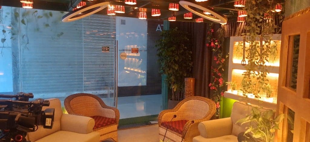 Biophilic Podcast Studio lounge with camera and warm lighting